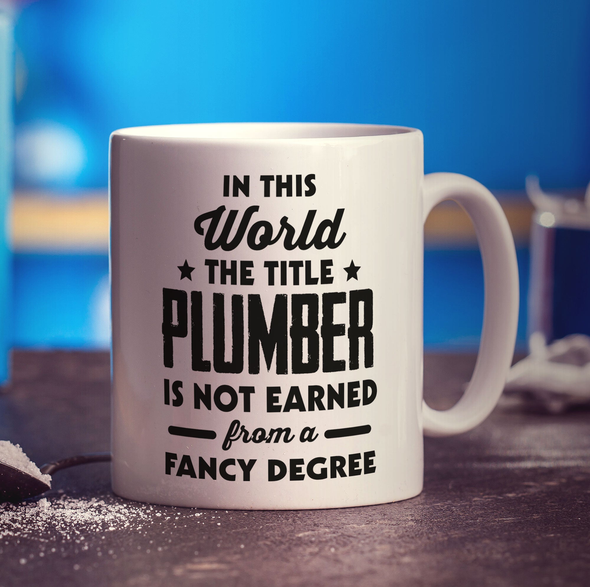 In This World The Title Plumber Is Not Earned From a Fancy Degree Mug - Standard 330ml (11oz) / White
