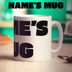 White mug with black text on a wooden surface